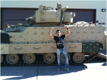 Photograph of Andy Hurwitz in front of a tank